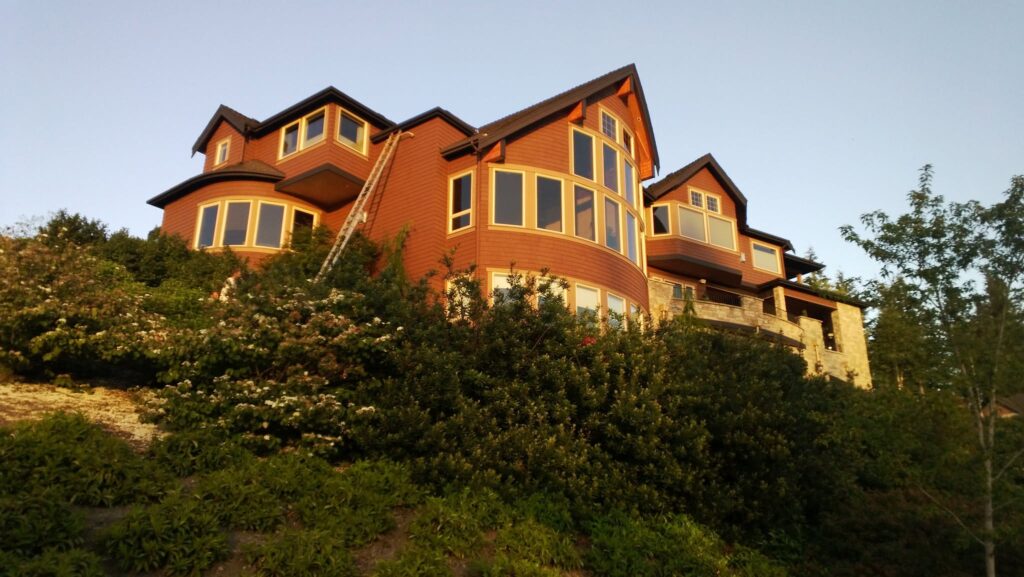 Residential House Staining Project - Remington Services Large custom home with freshly stained wood siding completed by Remington Services in Western Washington.